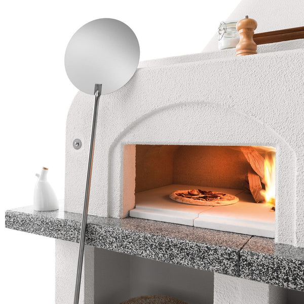 Palazzetti Antille 2 barbecue con forno a legna grezzo con braciere laterale con piano in Marmotech effetto granito grigio