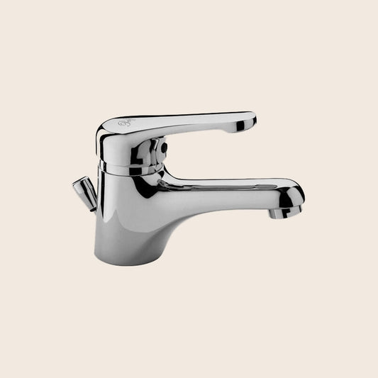 Paffoni Nettuno Nt070 Miscelatore lavabo scarico automatico ambientato su piano bagno con accessori