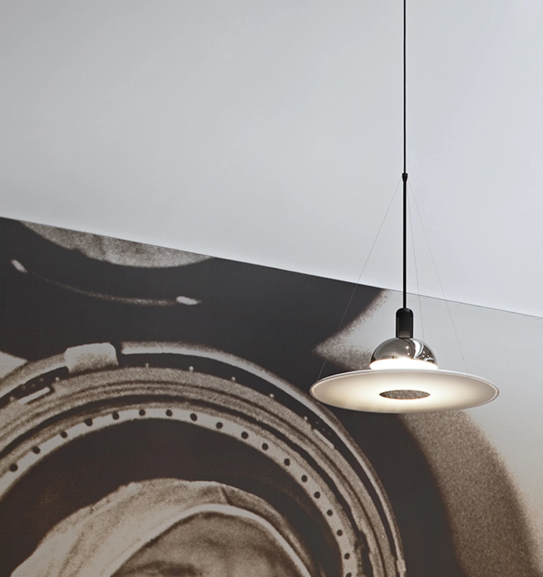 Flos Frisbi Lampada Sospesa Cromo in cromato accesa in ambiente, design e diffusione della luce
