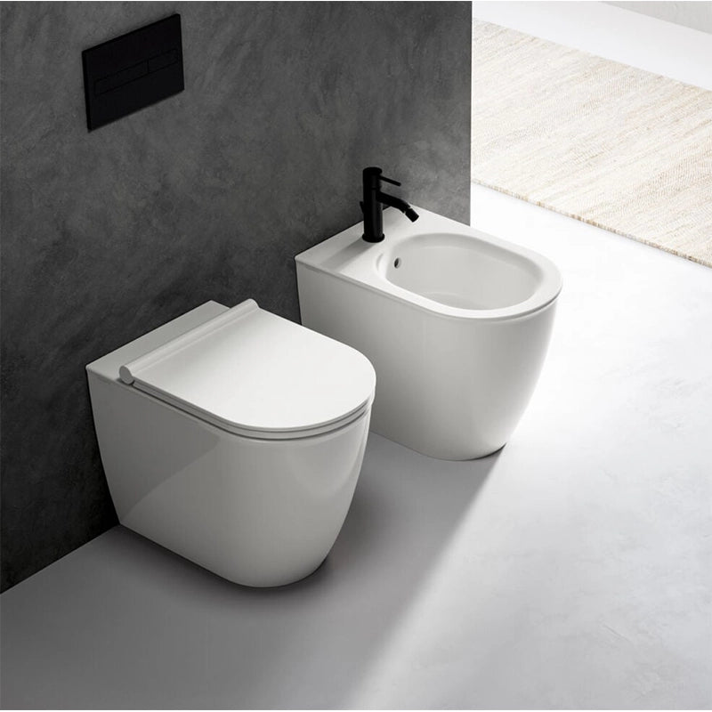 Ceramica Dolomite Coppia sanitari filomuro con sedile in lucido ambientato su piano bagno con accessori