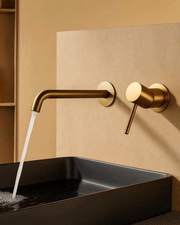Rubinetto lavabo da incasso a muro in oro spazzolato Memo in ottone ambientato su piano bagno con accessori - Exagonshop