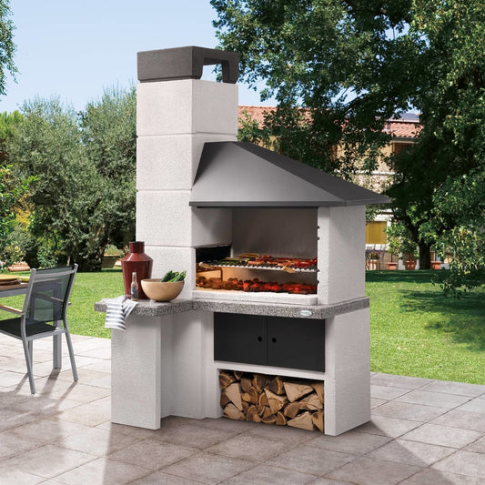 Palazzetti Faro New barbecue con braciere laterale e cappa Grigio accesa in soggiorno, fiamma visibile attraverso il vetro