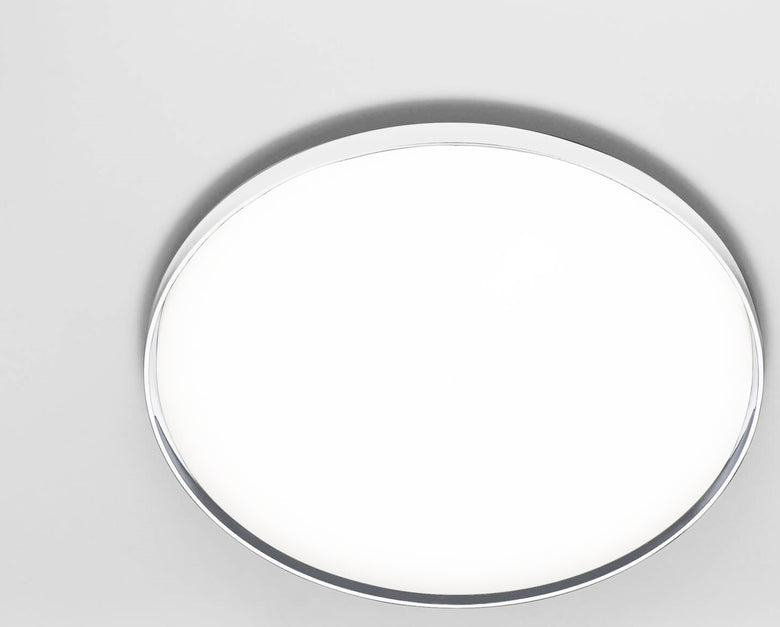 Flos Clara Lampada a parete e soffitto 60 cm cornice in policarbonato accesa in ambiente, design e diffusione della luce