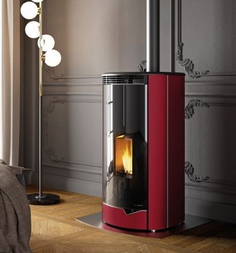 Stufa ermetica A Pellet Ecofire ad Aria con uscita fumi Rossa accesa in soggiorno, fiamma visibile attraverso il vetro